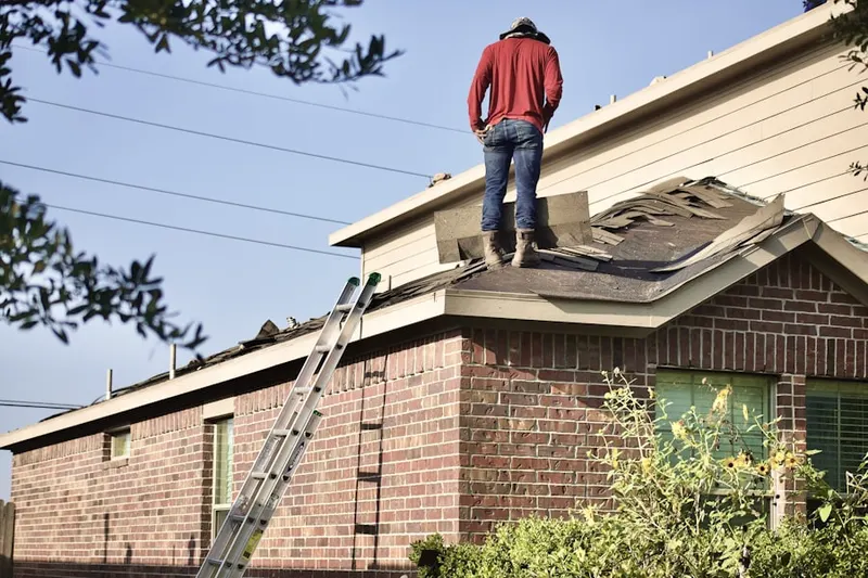 Professional roofer working on a residential roof in Pflugerville